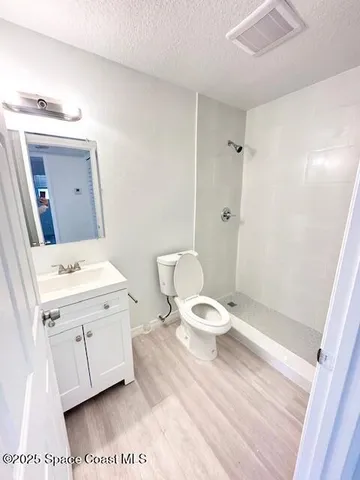 a bathroom with a toilet sink and a mirror