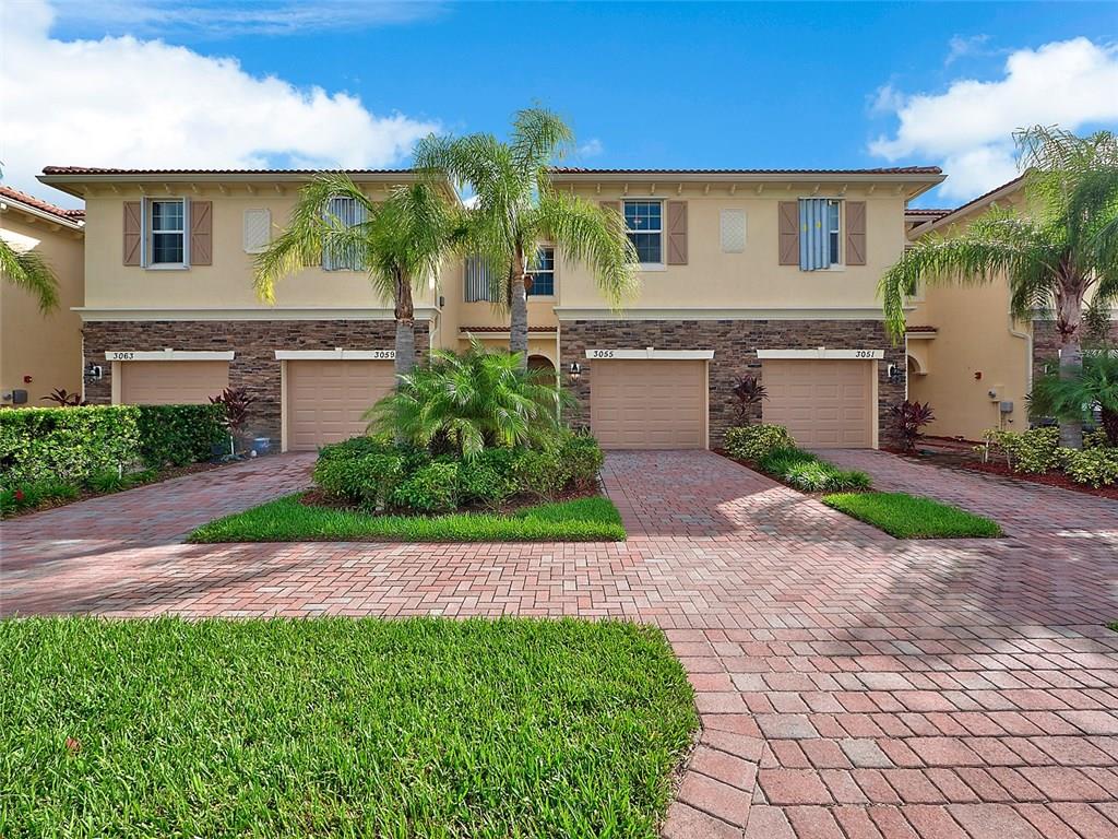 3055 Southwest Otter Lane Stuart, FL 34997 - Photo 1 of 13 a front view of a house with garden