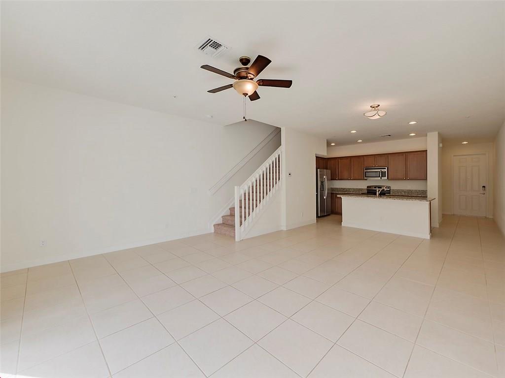 3055 Southwest Otter Lane Stuart, FL 34997 - Photo 3 of 13 a view of a kitchen with a sink and dishwasher a refrigerator with white cabinets