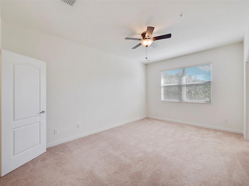 3055 Southwest Otter Lane Stuart, FL 34997 - Photo 6 of 13 an empty room with windows and fan