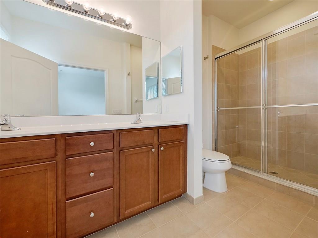 3055 Southwest Otter Lane Stuart, FL 34997 - Photo 7 of 13 a bathroom with a sink a toilet and shower
