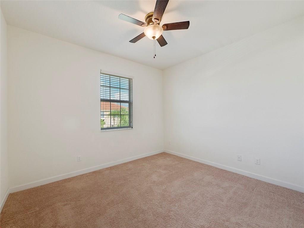 3055 Southwest Otter Lane Stuart, FL 34997 - Photo 8 of 13 an empty room with windows and fan