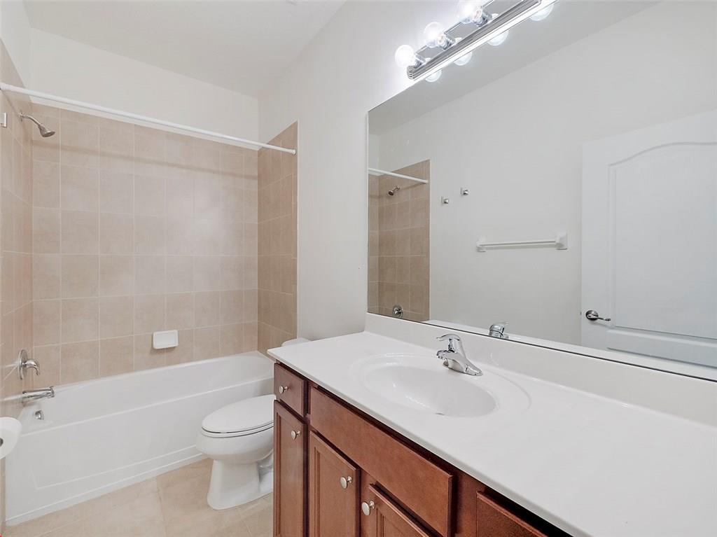3055 Southwest Otter Lane Stuart, FL 34997 - Photo 9 of 13 a bathroom with a sink a toilet and shower