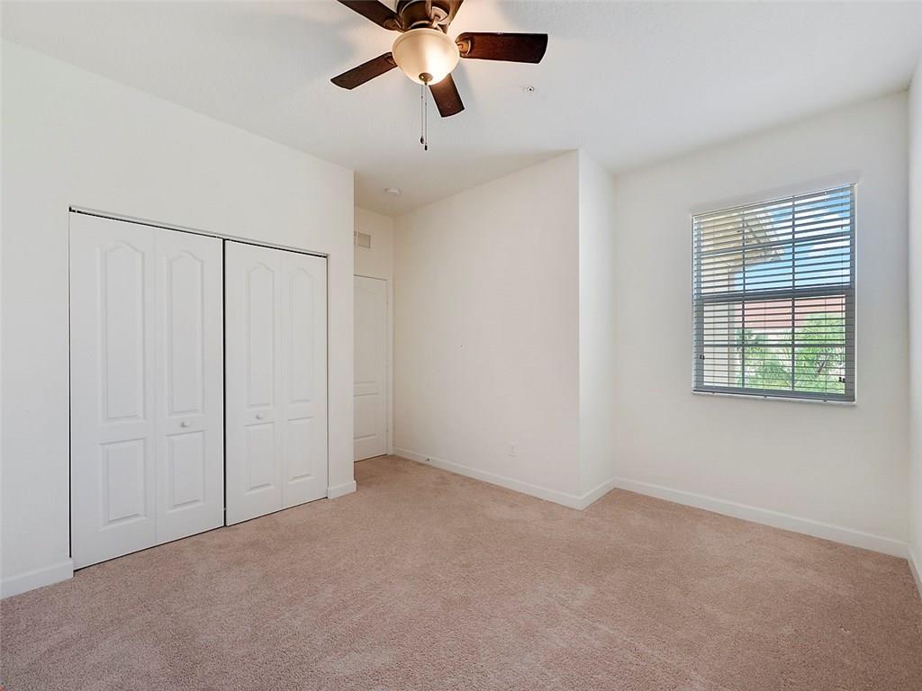 3055 Southwest Otter Lane Stuart, FL 34997 - Photo 10 of 13 an empty room with windows and fan
