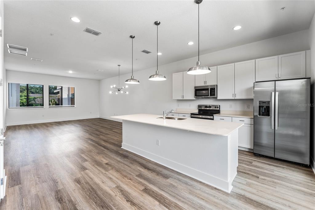 38 West Harding Street, Unit C Orlando, FL 32806 - Photo 15 of 32 a kitchen with kitchen island a counter space a sink appliances and a floor