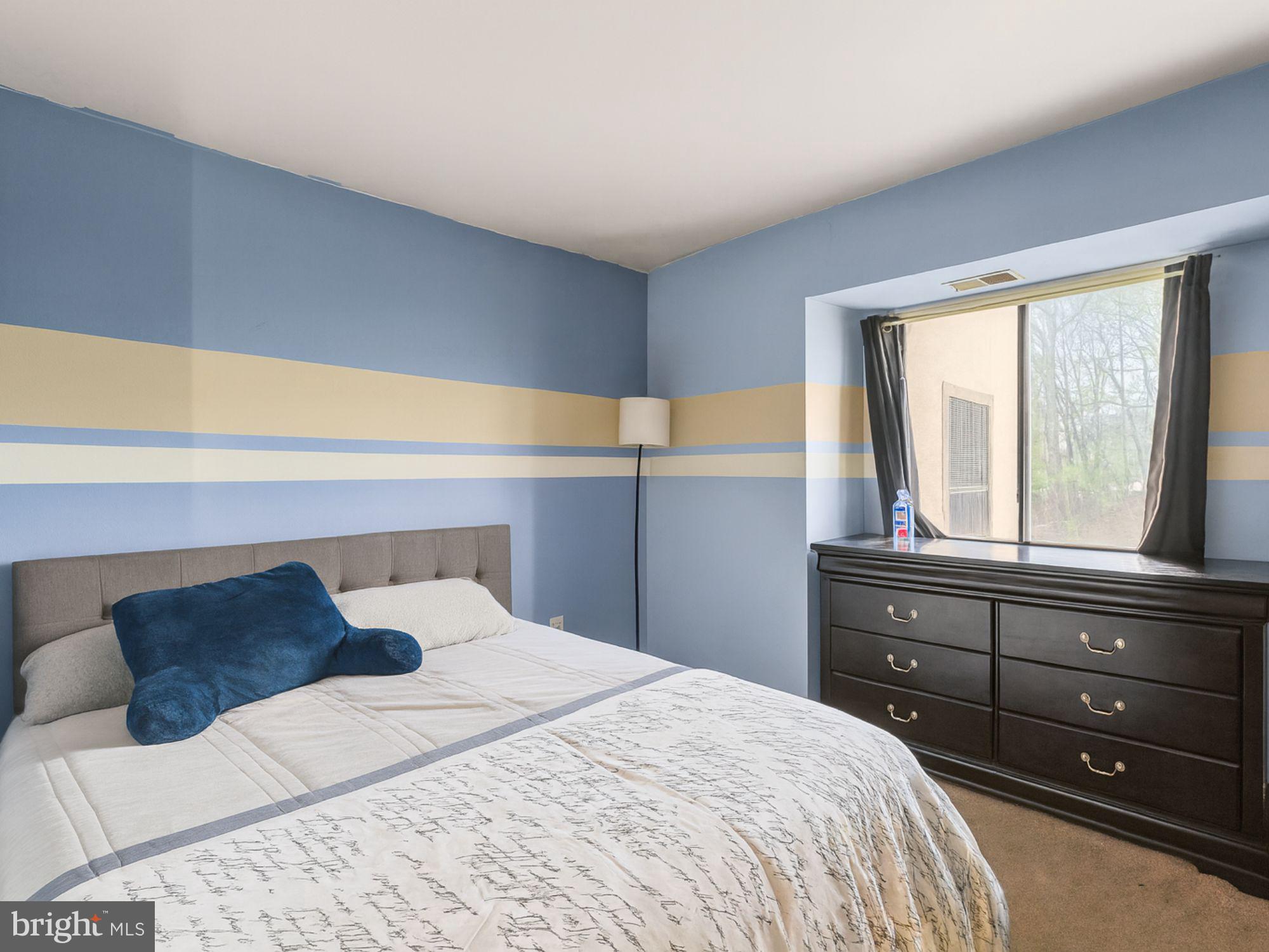 15708 Dorset Road, Unit 177 Laurel, MD 20707 - Photo 12 of 25 a bedroom with a bed and window with lamp