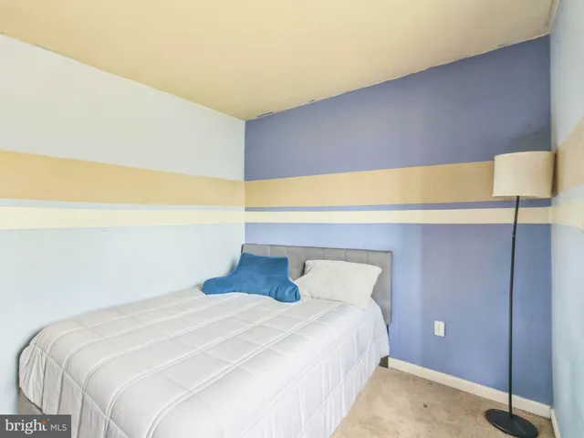 a bedroom with a bed and lamp