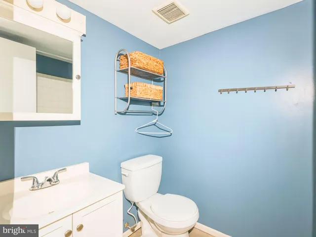 a white toilet sitting next to a bathroom sink