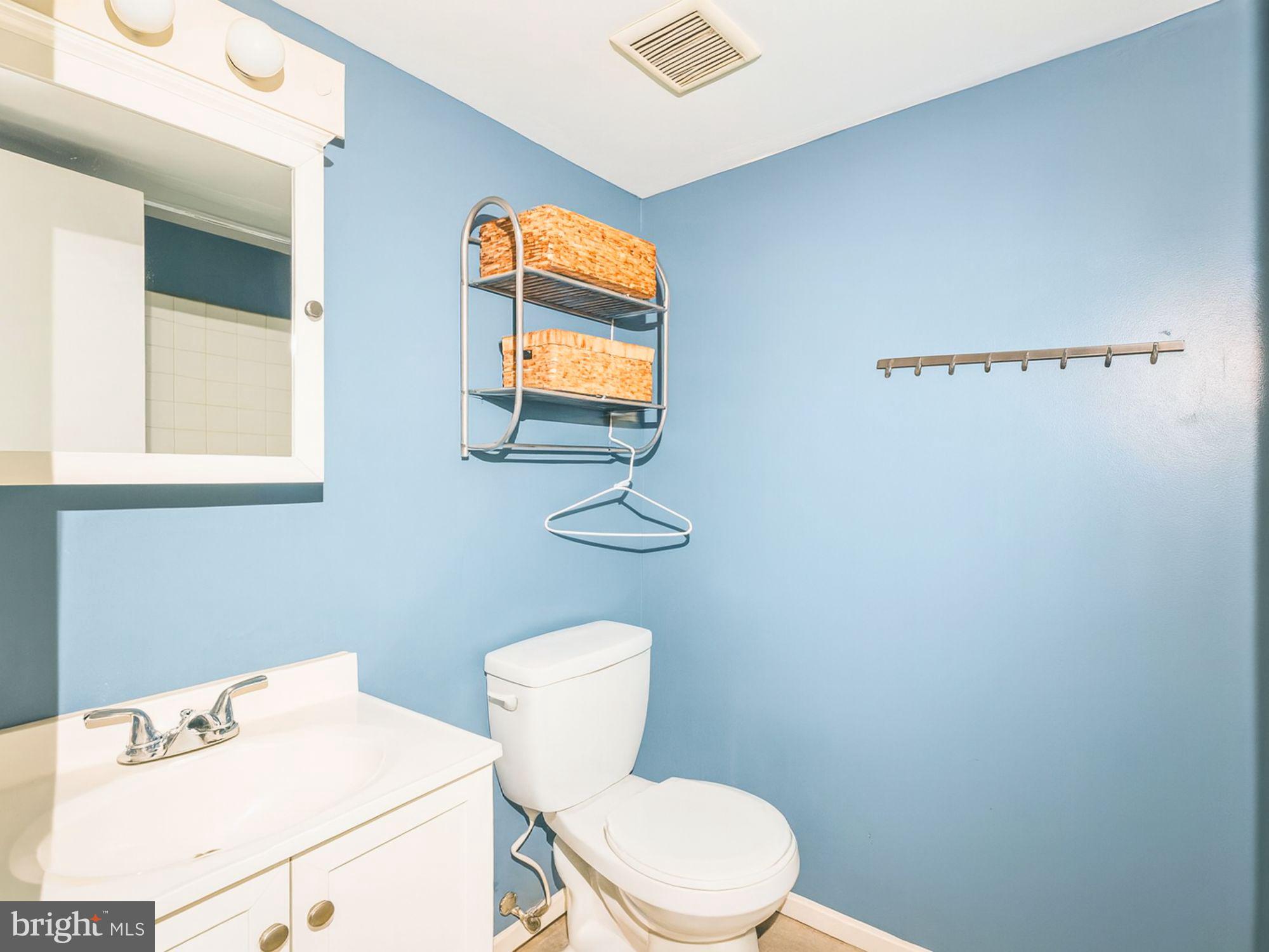 15708 Dorset Road, Unit 177 Laurel, MD 20707 - Photo 19 of 25 a white toilet sitting next to a bathroom sink