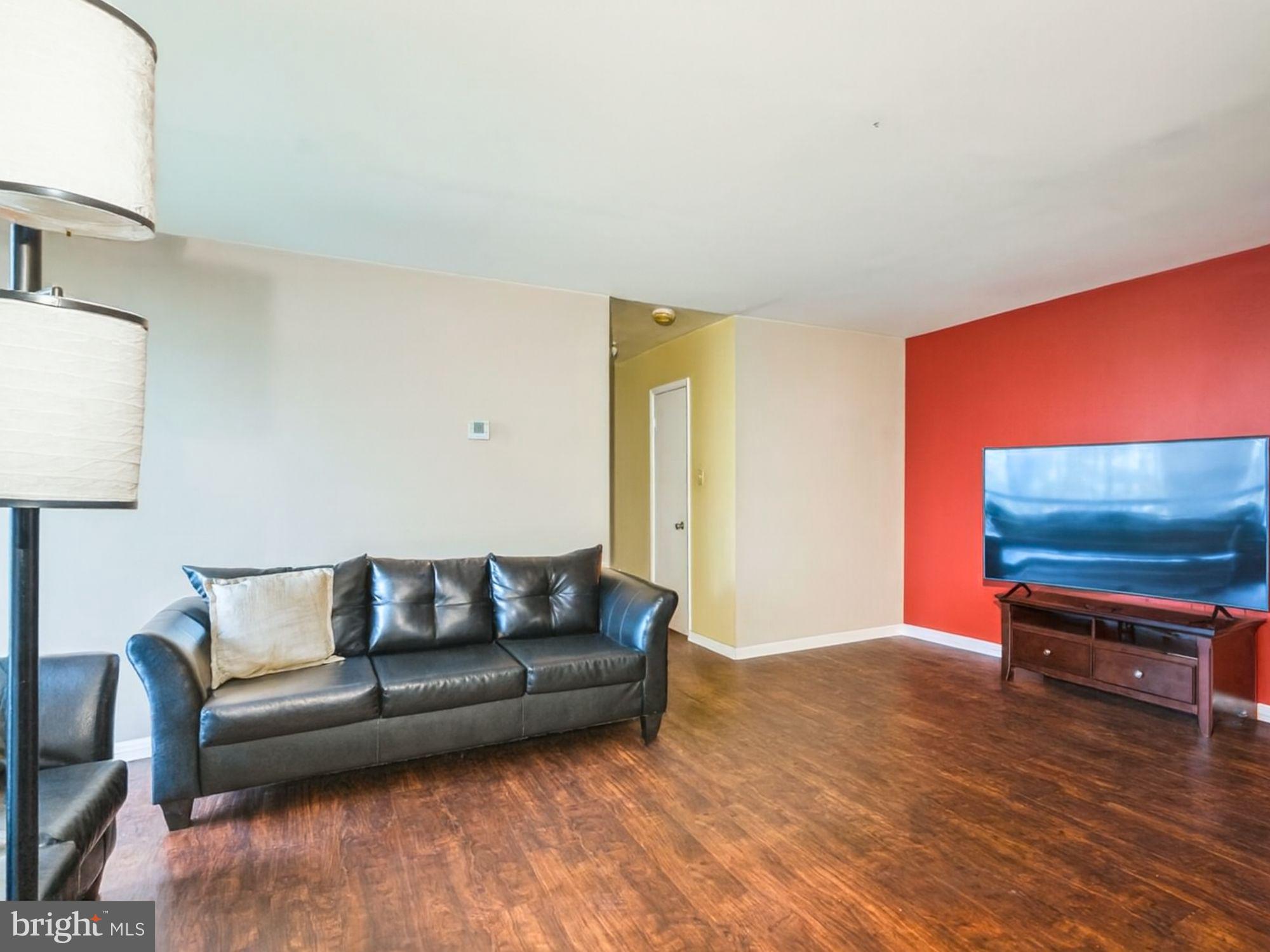 15708 Dorset Road, Unit 177 Laurel, MD 20707 - Photo 2 of 25 a living room with furniture and a flat screen tv