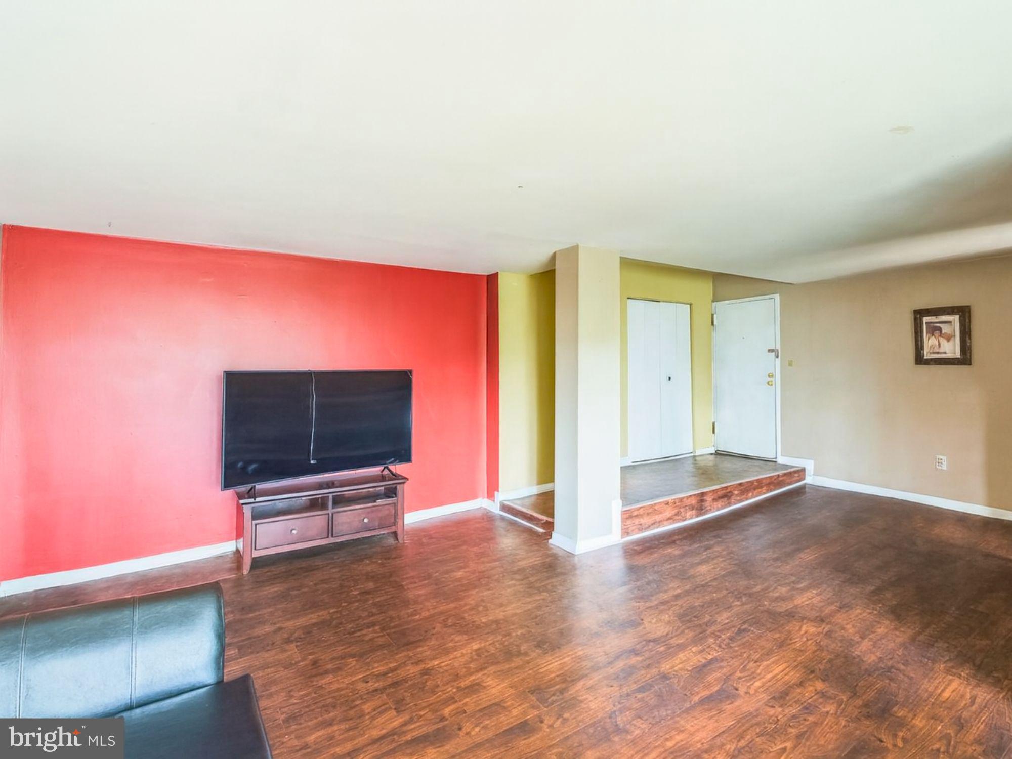 15708 Dorset Road, Unit 177 Laurel, MD 20707 - Photo 3 of 25 a view of an empty room with wooden floor and furniture