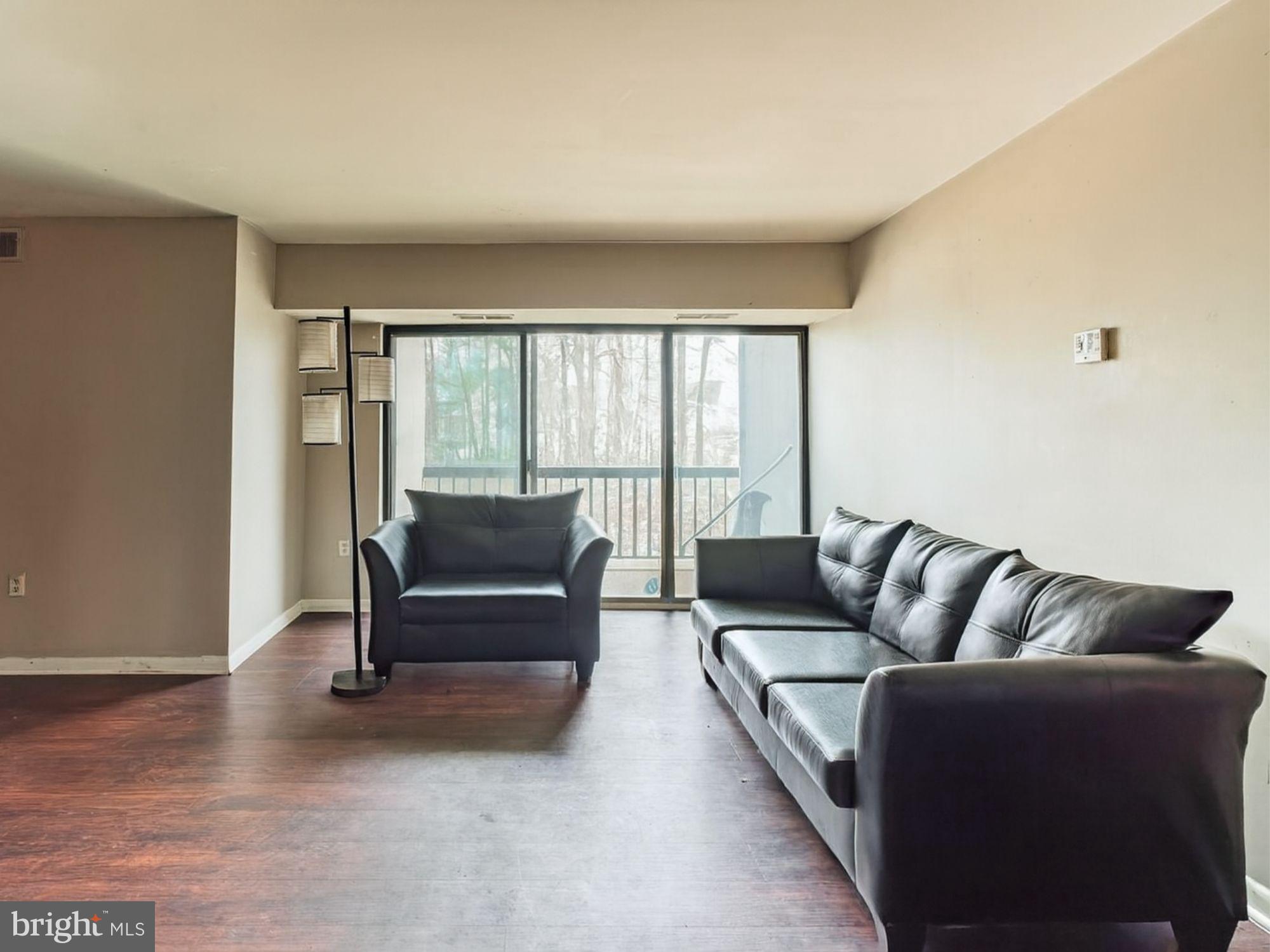 15708 Dorset Road, Unit 177 Laurel, MD 20707 - Photo 4 of 25 a living room with furniture and a floor to ceiling window