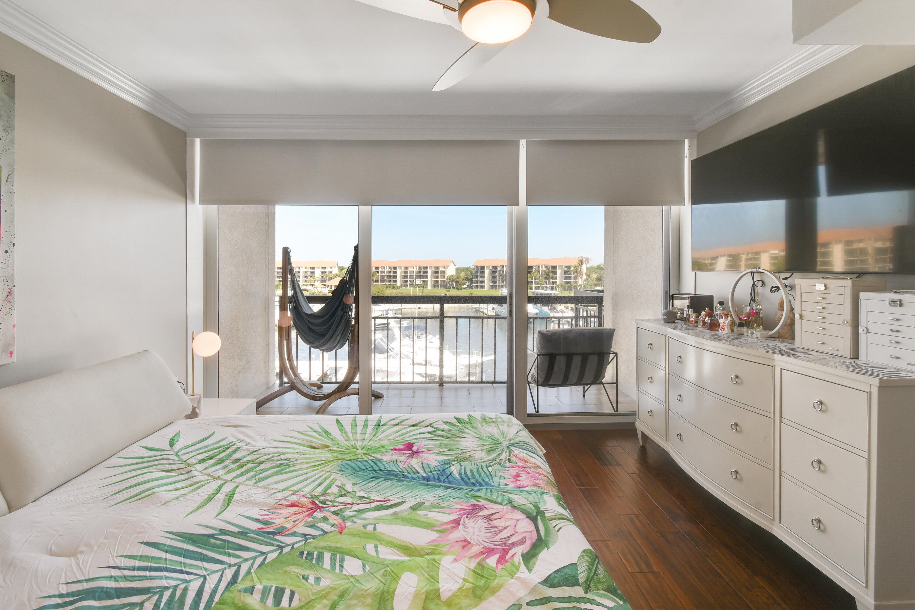 2401 Marina Isle Way, Unit 503 Jupiter, FL 33477 - Photo 18 of 46 a bed sitting in a bedroom next to a window