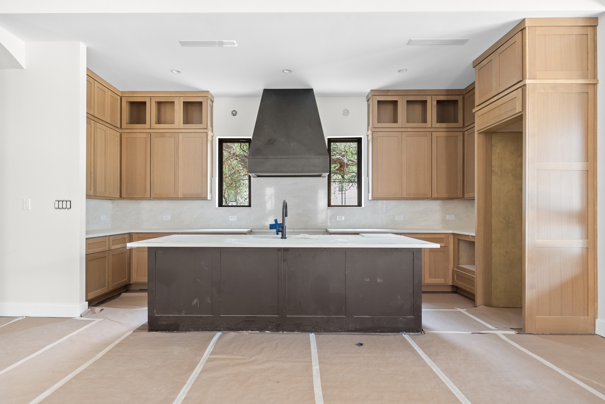 903 Flint Ridge Trail Georgetown, TX 78628 - Photo 8 of 39 Central kitchen island with a dark-toned finish and white countertop
