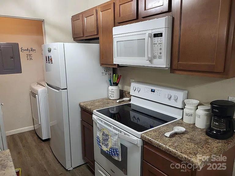 a kitchen with a refrigerator sink and cabinets