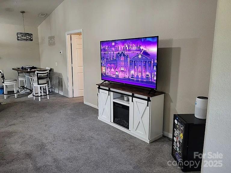 897 Fording Island Road, Unit 2208 Bluffton, SC 29910 - Photo 15 of 29 a view of a room with furniture and a flat screen tv