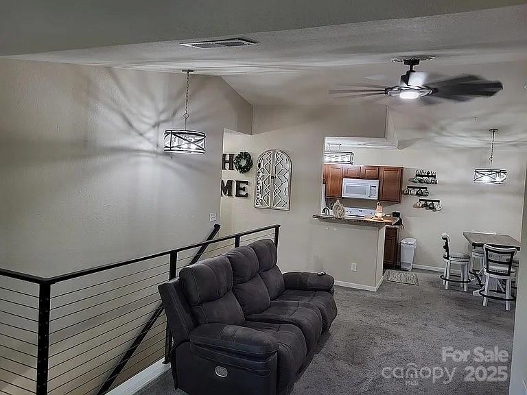 897 Fording Island Road, Unit 2208 Bluffton, SC 29910 - Photo 3 of 29 a living room with furniture and kitchen view