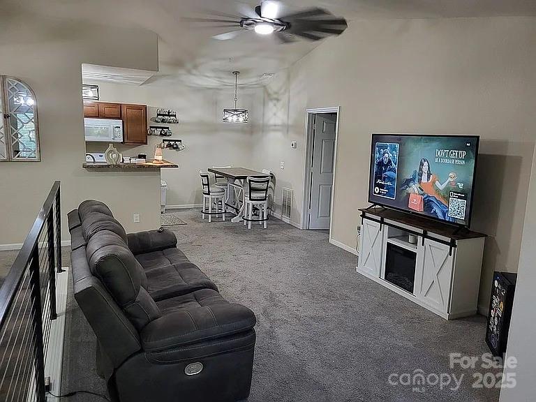 897 Fording Island Road, Unit 2208 Bluffton, SC 29910 - Photo 4 of 29 a living room with furniture and a flat screen tv