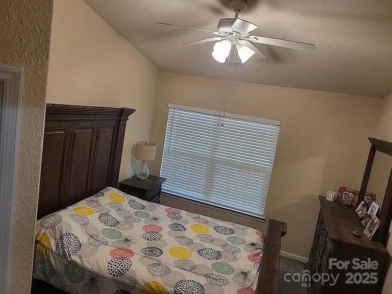 897 Fording Island Road, Unit 2208 Bluffton, SC 29910 - Photo 6 of 29 a bedroom with a bed and a chandelier