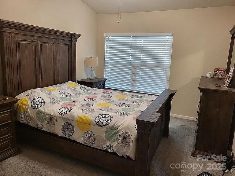 897 Fording Island Road, Unit 2208 Bluffton, SC 29910 - Photo 7 of 29 a bedroom with a bed and wooden floor