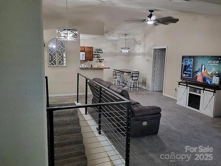 897 Fording Island Road, Unit 2208 Bluffton, SC 29910 - Photo 9 of 29 a living room with furniture and a chandelier