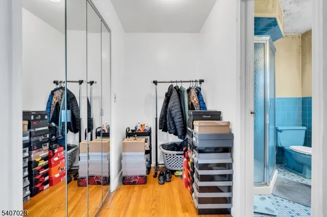 a view of walk in closet with clothes and shoes