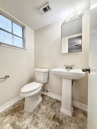 a bathroom with a sink toilet and mirror