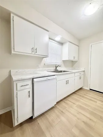 a kitchen with white cabinets sink and white appliances