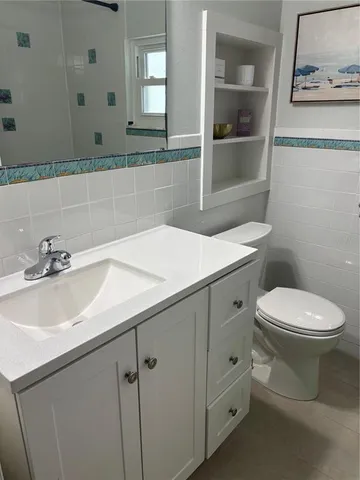 a bathroom with a sink toilet and vanity