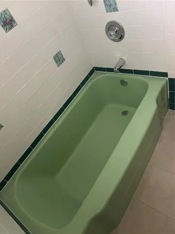 a bathroom with a green tub