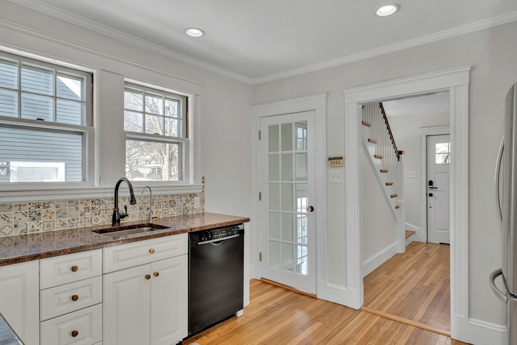 10 Dexter Road Lexington, MA 02420 - Photo 17 of 35 a kitchen with granite countertop a sink and cabinets