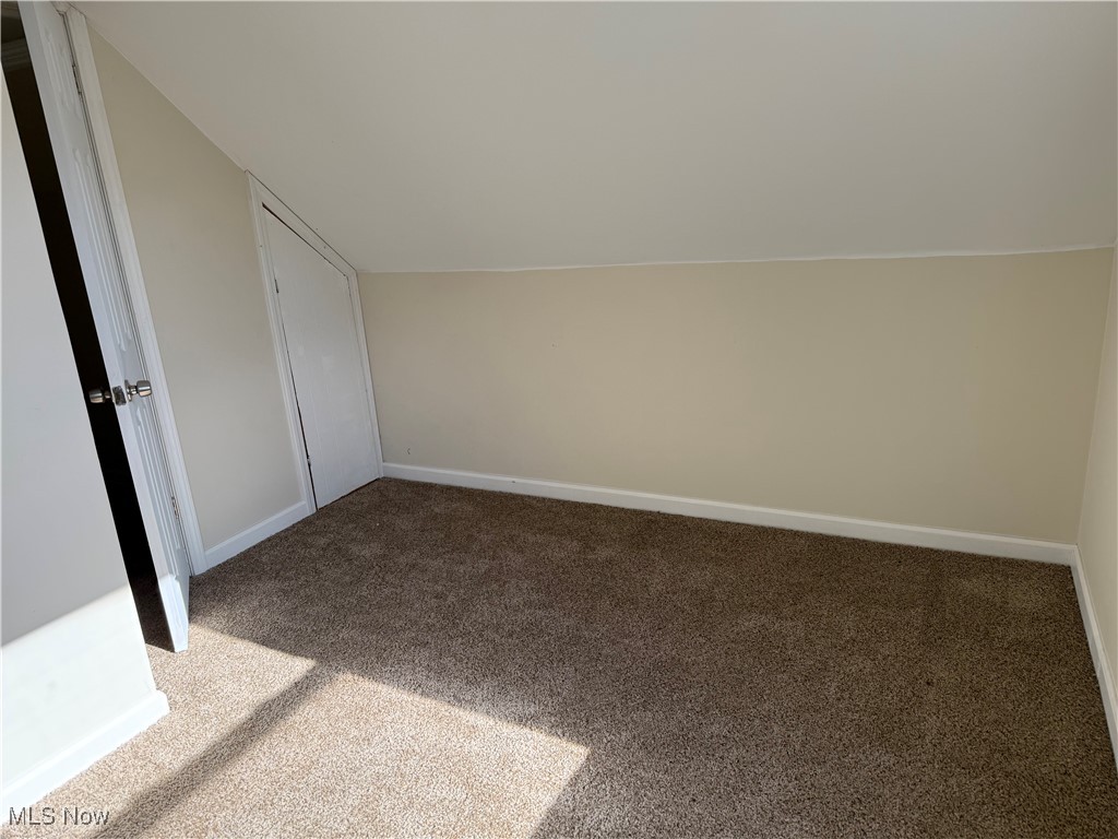 1877 Clyde Road Madison, OH 44057 - Photo 11 of 19 Additional living space with carpet and vaulted ceiling