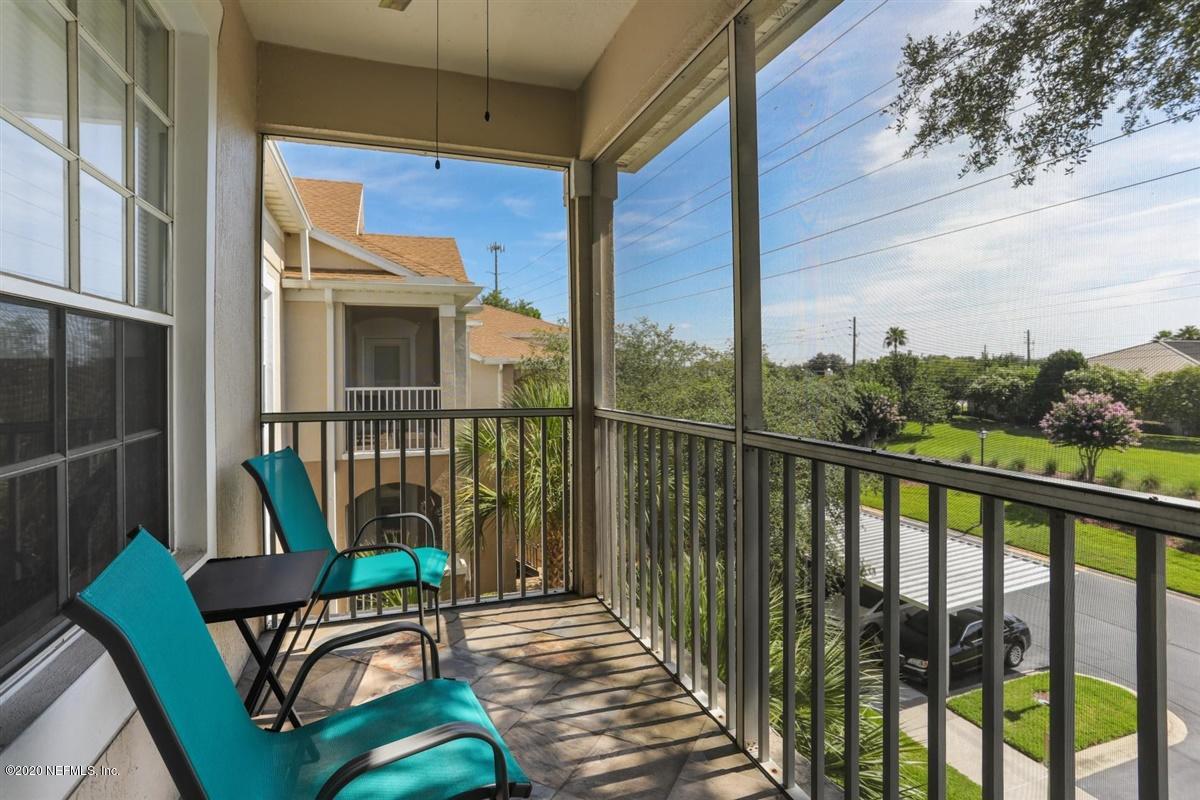 a porch with a bench next to a yard