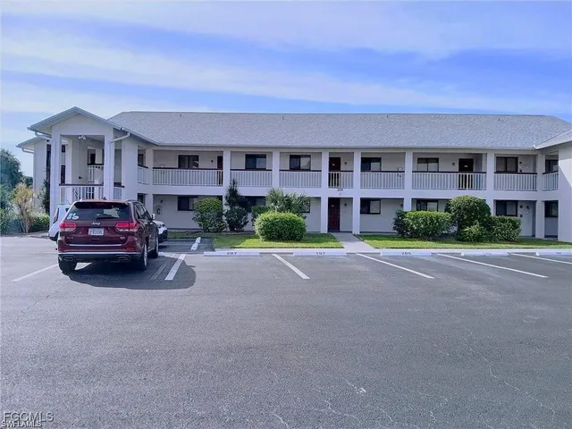 a car parked in front of a brick building next to a road