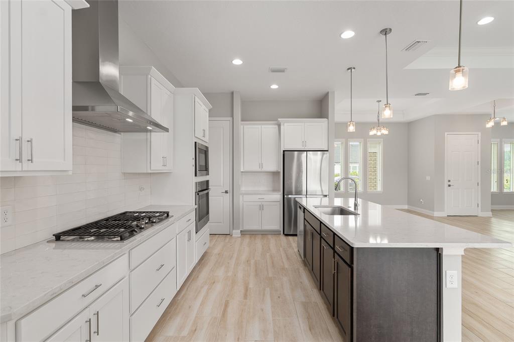 12048 Southwest 35th Place Gainesville, FL 32608 - Photo 14 of 53 a kitchen with stainless steel appliances a sink stove and cabinets
