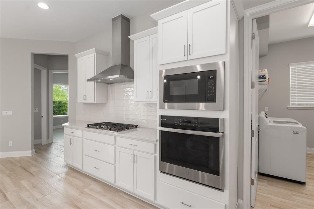 12048 Southwest 35th Place Gainesville, FL 32608 - Photo 15 of 53 a kitchen with stainless steel appliances granite countertop a stove and a microwave