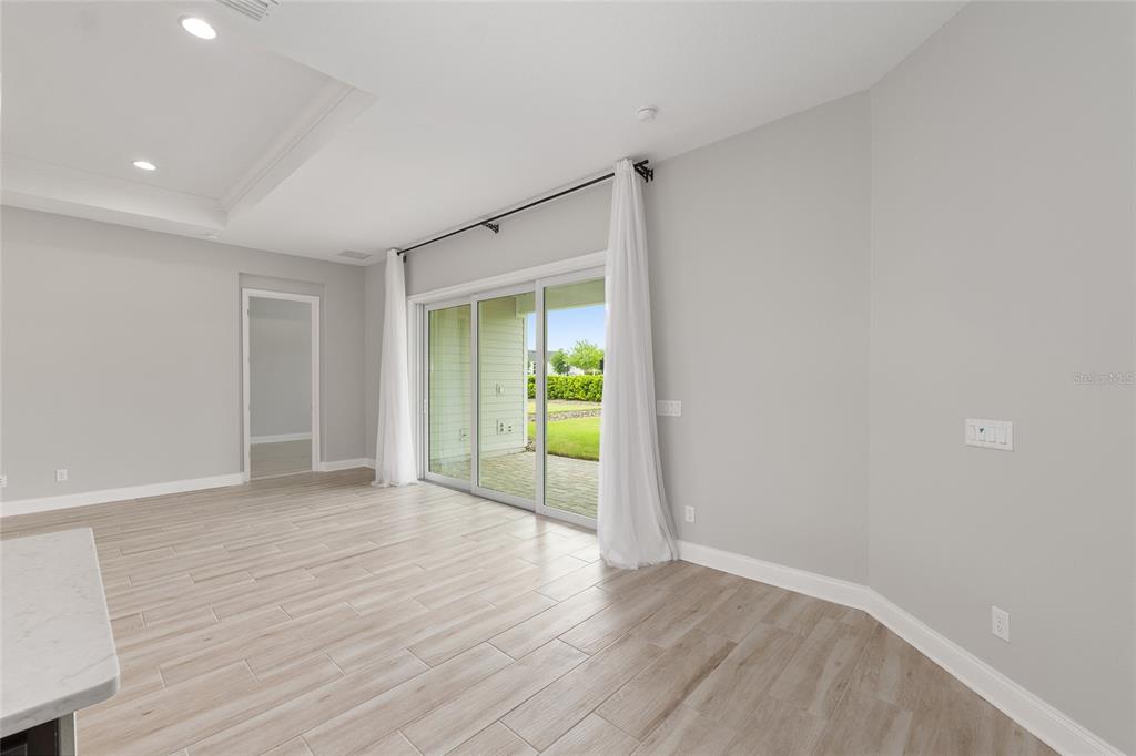 12048 Southwest 35th Place Gainesville, FL 32608 - Photo 19 of 53 a view of an empty room with wooden floor and a window