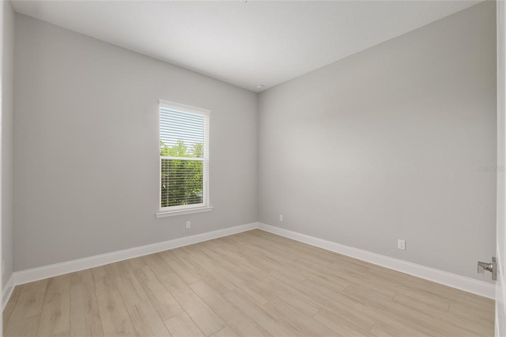 12048 Southwest 35th Place Gainesville, FL 32608 - Photo 24 of 53 an empty room with wooden floor and windows