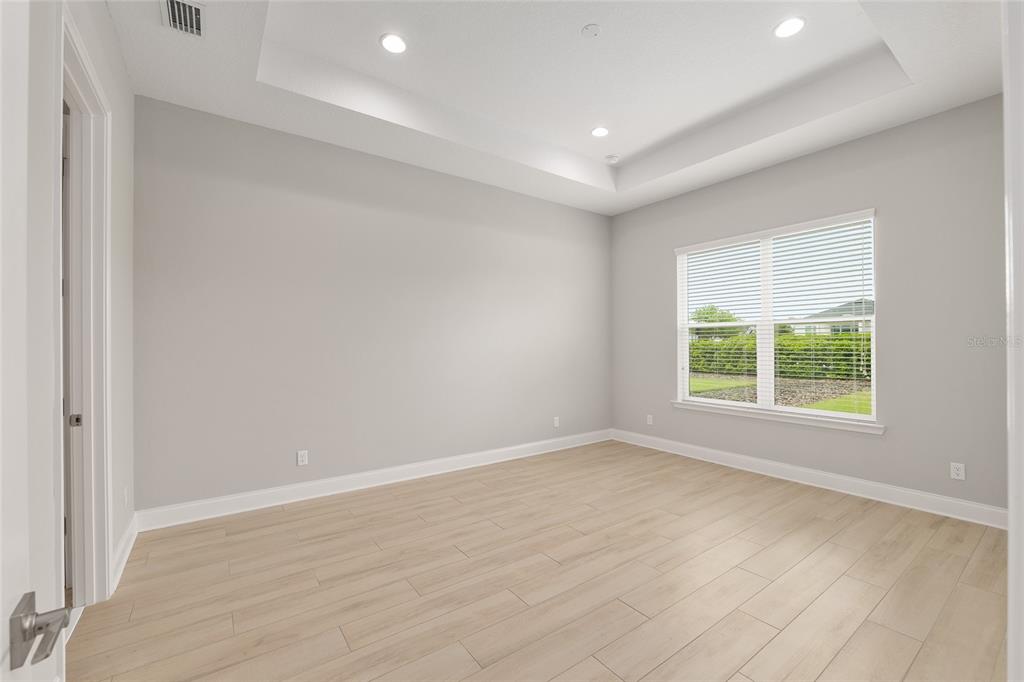 12048 Southwest 35th Place Gainesville, FL 32608 - Photo 26 of 53 an empty room with wooden floor and windows