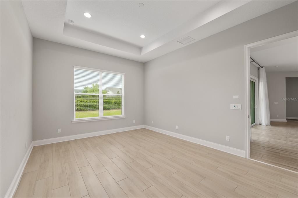 12048 Southwest 35th Place Gainesville, FL 32608 - Photo 27 of 53 an empty room with wooden floor and windows