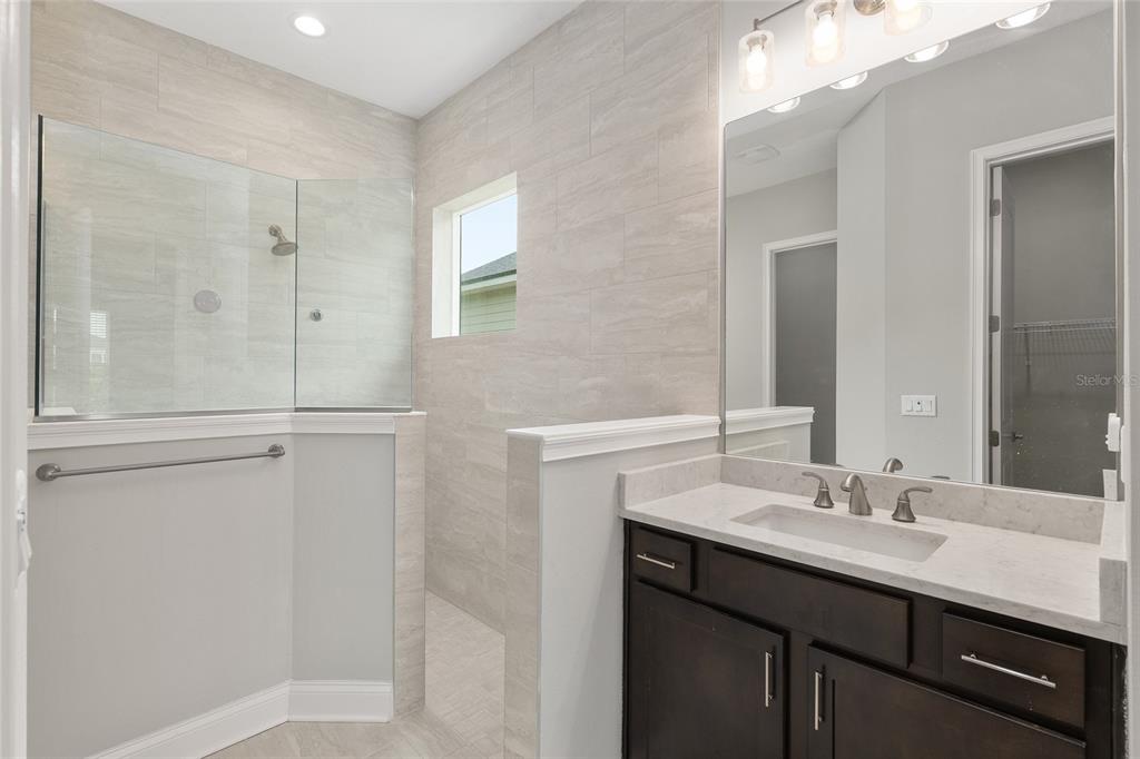 12048 Southwest 35th Place Gainesville, FL 32608 - Photo 29 of 53 a bathroom with a sink and a mirror