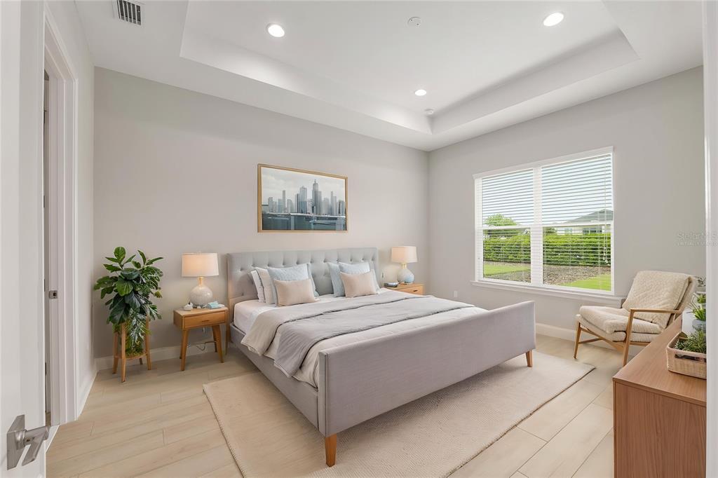 12048 Southwest 35th Place Gainesville, FL 32608 - Photo 3 of 53 a bedroom with a large bed and potted plant