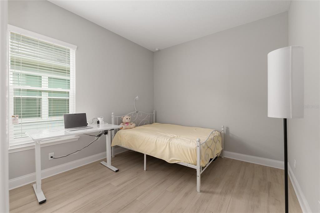 12048 Southwest 35th Place Gainesville, FL 32608 - Photo 32 of 53 a bedroom with a bed and a window