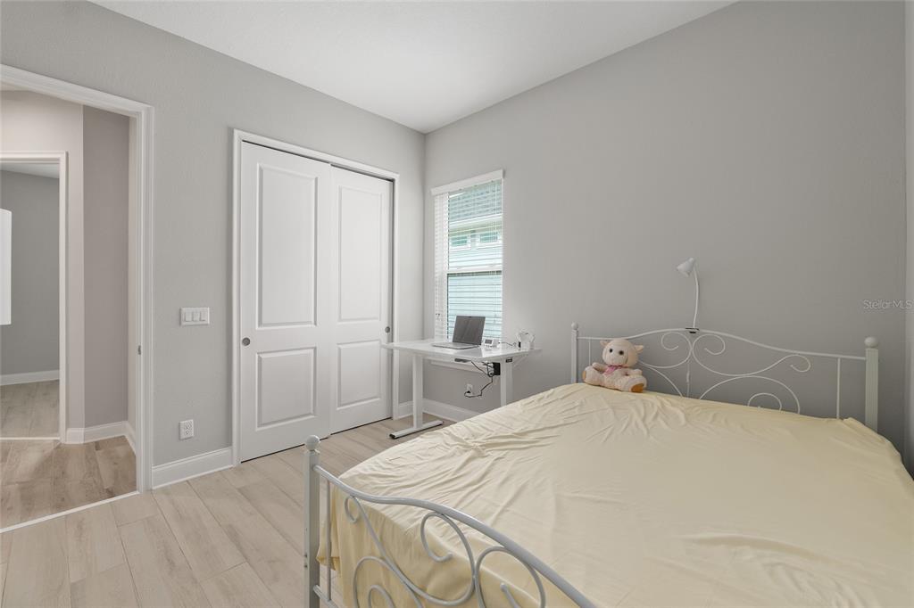 12048 Southwest 35th Place Gainesville, FL 32608 - Photo 33 of 53 a bedroom with a bed and a window