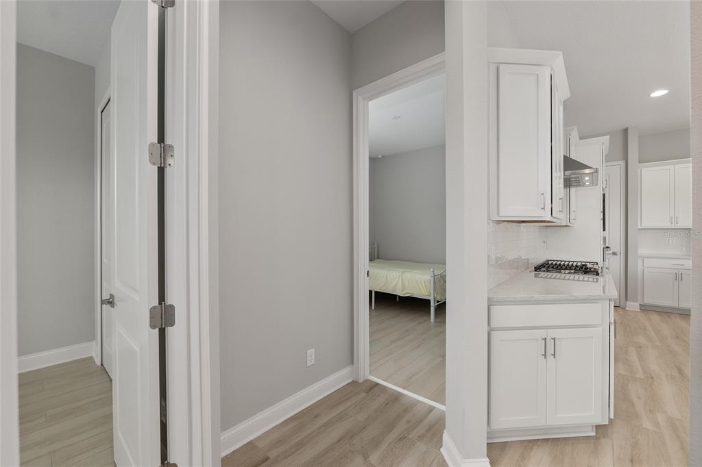 12048 Southwest 35th Place Gainesville, FL 32608 - Photo 34 of 53 a kitchen with a refrigerator and white cabinets