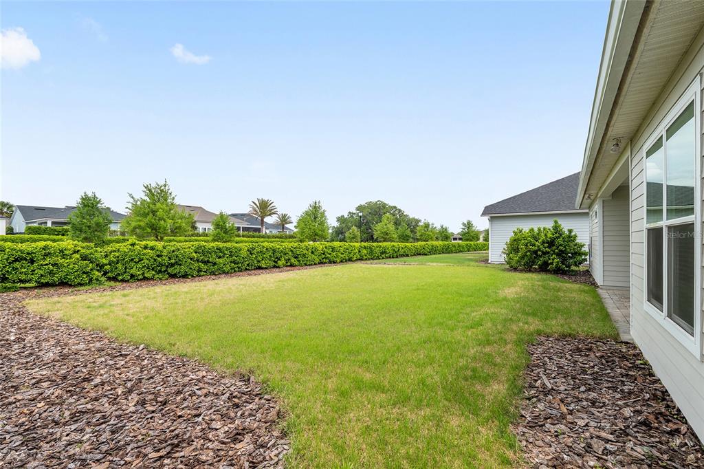 12048 Southwest 35th Place Gainesville, FL 32608 - Photo 45 of 53 a view of a garden with a building in the background