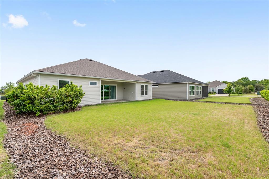 12048 Southwest 35th Place Gainesville, FL 32608 - Photo 49 of 53 a front view of a house with a yard