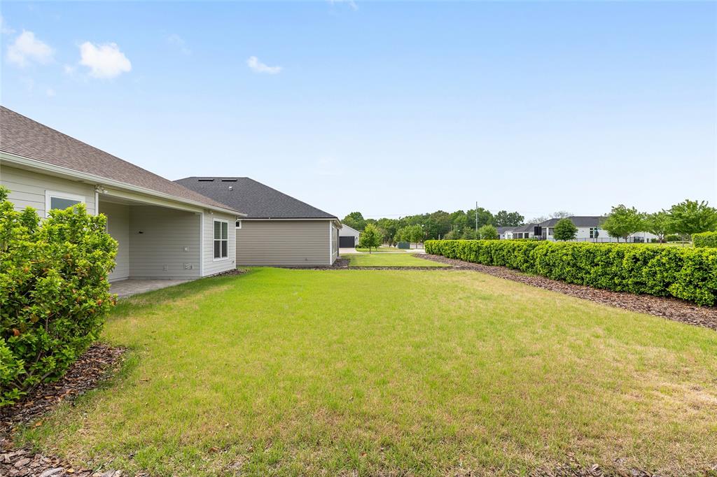 12048 Southwest 35th Place Gainesville, FL 32608 - Photo 50 of 53 a view of a house with pool and a yard
