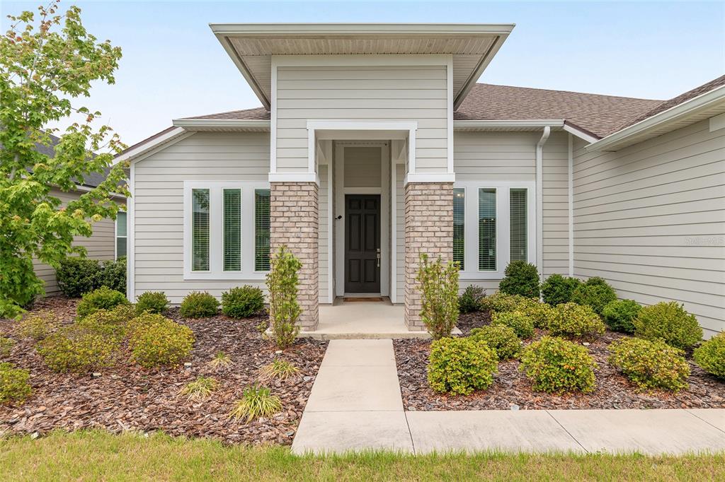 12048 Southwest 35th Place Gainesville, FL 32608 - Photo 6 of 53 a front view of a house with garden