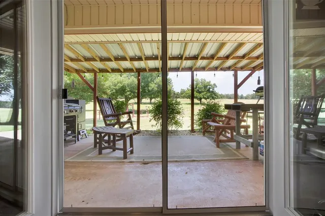 a view of a room with a floor to ceiling window and dining room